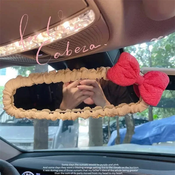 car accessories hanging from mirror  small pink bow